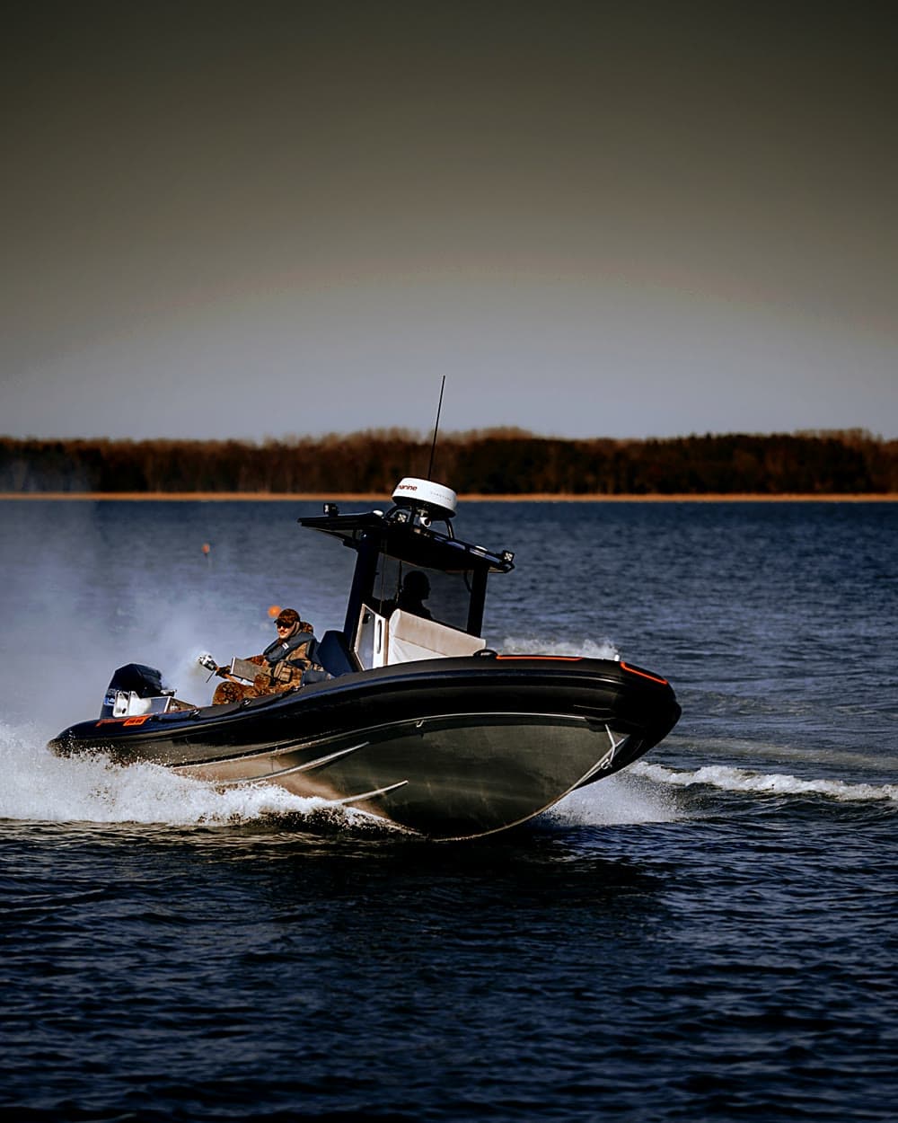 The 750 planing bow-on across open water